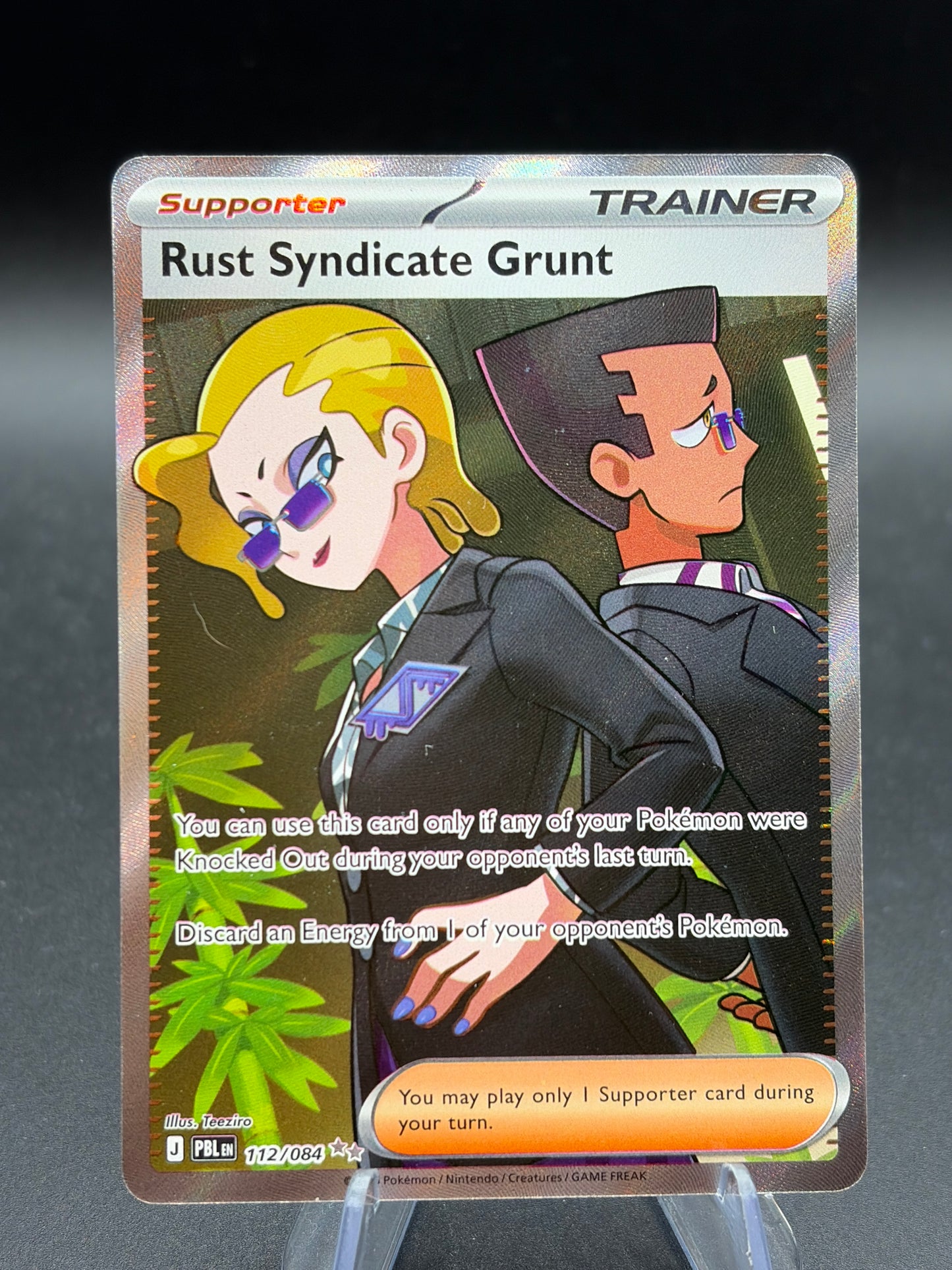 Pokémon TCG: 2026 Rust Syndicate Grunt - 112/084 - ME05: Pitch Black (PBL)